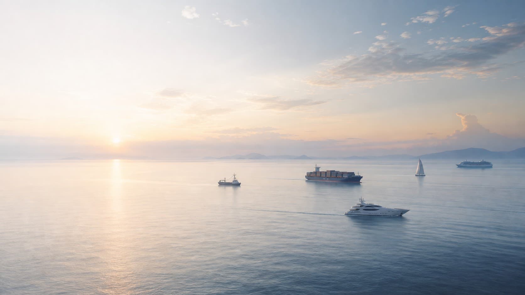 A calm ocean at sunrise with five distant ships navigating the same horizon.